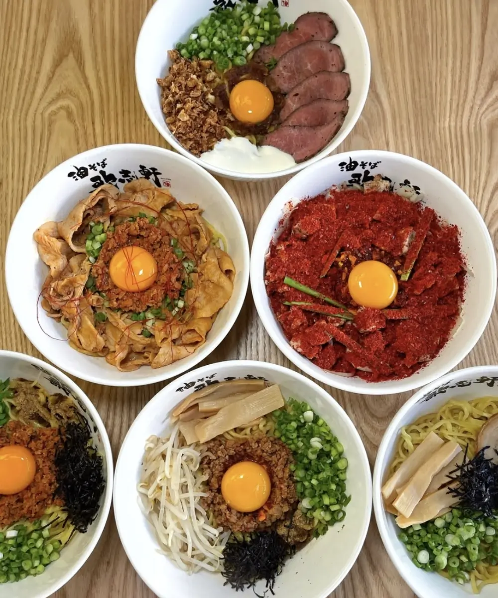 Assorted aburasoba bowls with egg and toppings at Kajiken-Fullerton, a Japanese Aburasoba Restaurant in Fullerton
